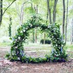 Locally grown wedding flowers forming a moongate in a woodland setting