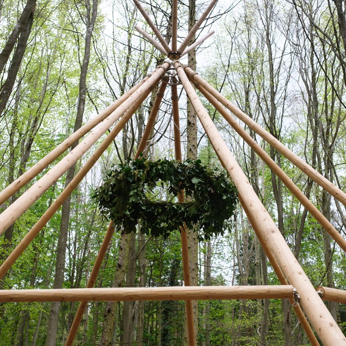 Outdoor ceremony tipi and flower hoop