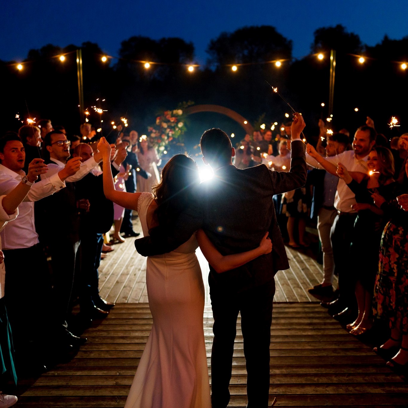 Wedding couple celebrating at outdoor wedding venue, Oxfordshire