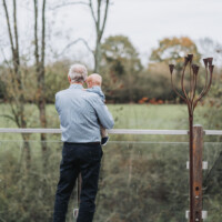 Grandfather and grandson at naming ceremony in Oxfordshire